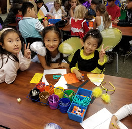 students drawing and cutting paper